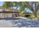 Exterior view of condo with carports and lush landscaping at 507 Pine Hollow Cir # 507, Englewood, FL 34223