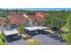 Exterior of property featuring private covered parking, mature landscaping, and tile roof at 507 Pine Hollow Cir # 507, Englewood, FL 34223