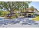 Exterior of condo showcasing covered parking, private entry, and mature trees at 507 Pine Hollow Cir # 507, Englewood, FL 34223