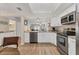 Open concept kitchen with granite countertops, stainless steel appliances and white cabinets that leads to a living room at 507 Pine Hollow Cir # 507, Englewood, FL 34223