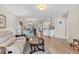 Open-concept living room with comfortable seating and seamless flow to dining area at 507 Pine Hollow Cir # 507, Englewood, FL 34223