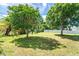 Large backyard with mature trees providing shade and a well-maintained lawn at 6206 Marcum St, Englewood, FL 34224