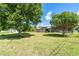 Expansive backyard with green grass and mature trees, ideal for outdoor enjoyment at 6206 Marcum St, Englewood, FL 34224