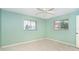 Empty bedroom featuring two windows and neutral-colored walls and flooring at 6206 Marcum St, Englewood, FL 34224