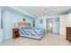 Spacious bedroom featuring a ceiling fan, a bed with a blue quilt, and bright natural light at 6206 Marcum St, Englewood, FL 34224