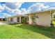 The well-maintained ranch-style home has a three-car garage and a grassy lot at 6206 Marcum St, Englewood, FL 34224