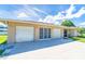 Exterior view of a three-car garage with an attached residence at 6206 Marcum St, Englewood, FL 34224