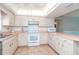 Cozy kitchen featuring ample cabinetry, tile floors, and modern appliances ready for meal preparation at 6206 Marcum St, Englewood, FL 34224