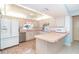 Bright kitchen with light wood cabinets, stainless appliances, and tile flooring at 6206 Marcum St, Englewood, FL 34224