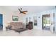 Cozy living room with tile floors, ceiling fan, and a view of the screened porch at 6206 Marcum St, Englewood, FL 34224