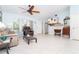 Spacious living room featuring neutral paint, tile floors, and a modern ceiling fan at 6206 Marcum St, Englewood, FL 34224