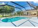 Inviting pool surrounded by a screened-in enclosure, offering an ideal space for relaxation and recreation at 6206 Marcum St, Englewood, FL 34224