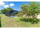 View of the refreshing pool enclosed by a screened-in lanai in a spacious backyard at 6206 Marcum St, Englewood, FL 34224