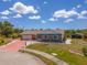 Aerial view showcasing a home with great curb appeal, stone landscaping, and a well-manicured lawn at 6417 Klaus Ct, Port Charlotte, FL 33981