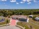 Aerial shot of home featuring a red driveway, shed and scenic backyard at 6417 Klaus Ct, Port Charlotte, FL 33981