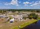 An aerial view of a charming home with a private pool, boat, and lush green lawn at 6417 Klaus Ct, Port Charlotte, FL 33981