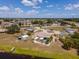 An aerial view showcasing homes in a quiet residential community near a lake at 6417 Klaus Ct, Port Charlotte, FL 33981