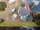 An aerial view features a home with a pool, additional buildings, and boat access to the lake at 6417 Klaus Ct, Port Charlotte, FL 33981