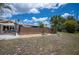 Backyard featuring a privacy fence, shade sail, bench, palm tree, and an open view of the canal at 6417 Klaus Ct, Port Charlotte, FL 33981