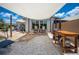 A backyard featuring a pair of rocking chairs in front of sliding glass doors with a partial shade sail overhead at 6417 Klaus Ct, Port Charlotte, FL 33981
