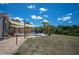 A backyard featuring a partial shade sail and a few lawn chairs with a canal in the background at 6417 Klaus Ct, Port Charlotte, FL 33981