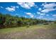 A canal view from a grassy backyard with a small boat docked on the waters edge at 6417 Klaus Ct, Port Charlotte, FL 33981