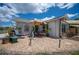 A backyard featuring decorative statues, shade umbrellas, a pair of rocking chairs, and canal views at 6417 Klaus Ct, Port Charlotte, FL 33981