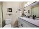 Bathroom features a white vanity with marble countertop, with matching wall decor at 6417 Klaus Ct, Port Charlotte, FL 33981
