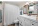 Bathroom features a white vanity, shower and matching toilet and shower curtain at 6417 Klaus Ct, Port Charlotte, FL 33981