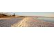 Tranquil beach scene with soft sand, a lighthouse, and gentle waves lapping the shore at 6417 Klaus Ct, Port Charlotte, FL 33981