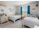 Inviting bedroom with matching twin beds, a window, and light wood-look flooring at 6417 Klaus Ct, Port Charlotte, FL 33981