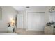 Neat and clean bedroom with white wood flooring, white closet doors, and a small nightstand at 6417 Klaus Ct, Port Charlotte, FL 33981