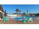 A view of the community pool with seating and palm trees at 6417 Klaus Ct, Port Charlotte, FL 33981