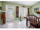 Bright dining room with white tile floors, a table, and a decorative window with ornate decor at 6417 Klaus Ct, Port Charlotte, FL 33981