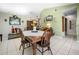 Dining Room offers a wooden table, white tile floors and a view to the kitchen at 6417 Klaus Ct, Port Charlotte, FL 33981
