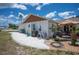 Exterior view of the home with a patio area and well-maintained landscaping with white stone at 6417 Klaus Ct, Port Charlotte, FL 33981