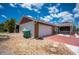 Exterior shot of home with garage, stone landscaping, and red driveway at 6417 Klaus Ct, Port Charlotte, FL 33981