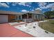 Charming home exterior with stone accents, a red driveway, and meticulously designed landscaping at 6417 Klaus Ct, Port Charlotte, FL 33981