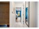 Hallway with a decorative blind, wood-look flooring, and access to additional rooms at 6417 Klaus Ct, Port Charlotte, FL 33981