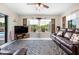 Spacious living room with large windows, pool view, leather furniture, and decorative rug at 6417 Klaus Ct, Port Charlotte, FL 33981