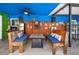 Covered outdoor seating area with a rustic style, featuring wooden benches and a fire pit table at 6417 Klaus Ct, Port Charlotte, FL 33981