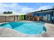 Beautiful pool with surrounding patio, shaded areas, and lush landscaping at 6417 Klaus Ct, Port Charlotte, FL 33981