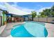 Outdoor pool area featuring a unique shape, covered seating, and ample space at 6417 Klaus Ct, Port Charlotte, FL 33981