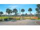 Outdoor tennis courts surrounded by palm trees create an inviting atmosphere for sports and recreation at 6417 Klaus Ct, Port Charlotte, FL 33981