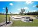 Outdoor bocce ball court with benches and a directional sign at 6461 Thorman Rd, Port Charlotte, FL 33981