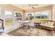 Bright sunroom with large windows, a dining table, and comfortable seating at 6461 Thorman Rd, Port Charlotte, FL 33981