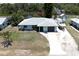 Aerial view of a quaint single Gathering home, including a front yard, driveway, and boat at 7234 Mamouth St, Englewood, FL 34224