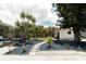 Landscaped backyard features a stone pathway, lush greenery, and a small shed near the screened-in pool area at 7234 Mamouth St, Englewood, FL 34224