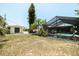 Backyard with a screened-in pool, small shed, and lawn area, perfect for relaxing or entertaining at 7234 Mamouth St, Englewood, FL 34224