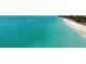 Beautiful shoreline featuring crystal-clear turquoise waters meeting a sandy beach, perfect for coastal living at 7234 Mamouth St, Englewood, FL 34224